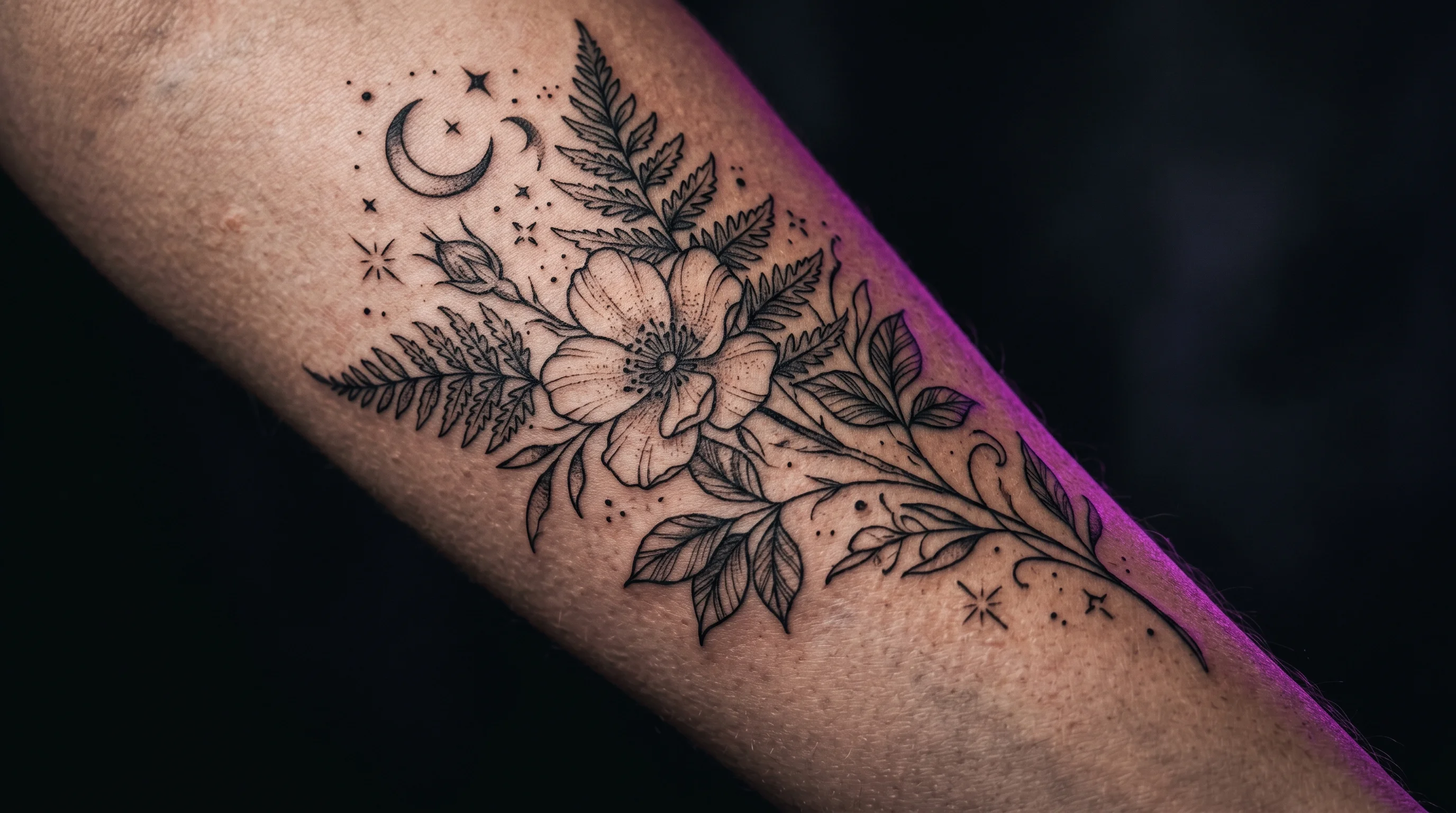 Fine-line botanical tattoo on bare outer hip and upper thigh, dramatic side lighting, dark background, editorial skin photography